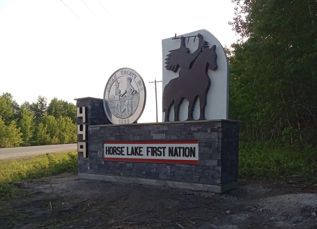 Horse Lake First Nation entrance monument with Treaty 8 medallion and rider silhouette