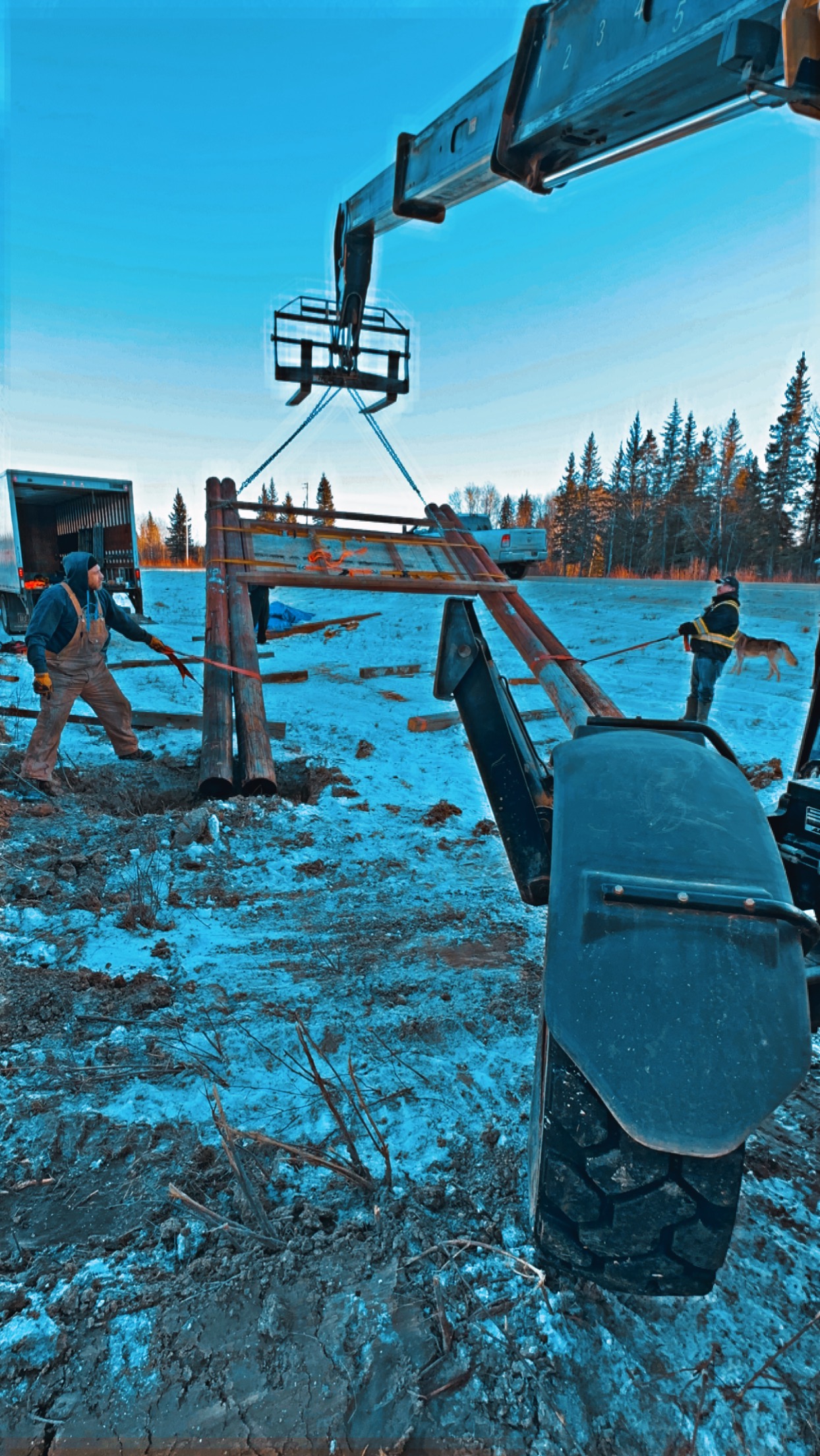 Telehandler lifting heavy timber sign frame at Moniyaw Sakahikan install site