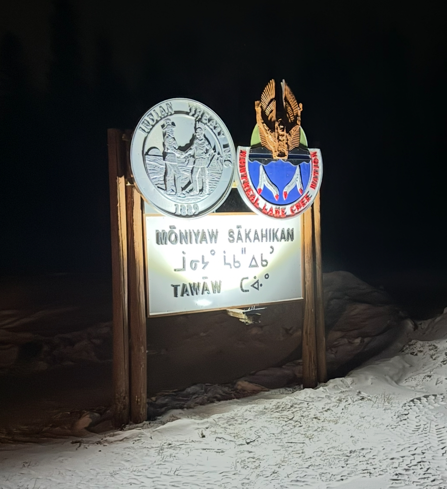 Montreal Lake Cree Nation Moniyaw Sakahikan community entrance sign illuminated at night